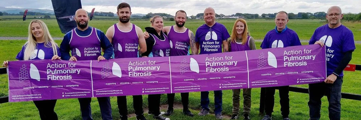 Fundraising Team holding APF banner