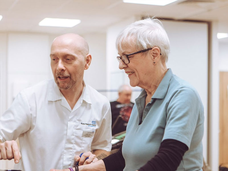 Man demonstrating equipment to patient