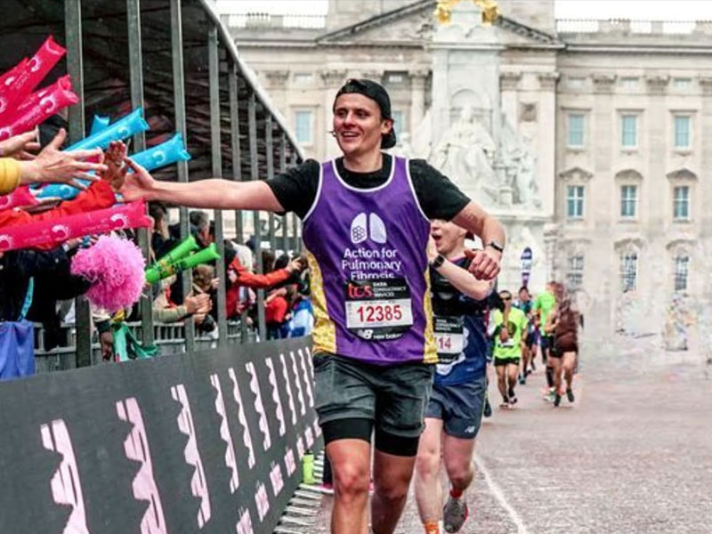 Runner high fiving crowd