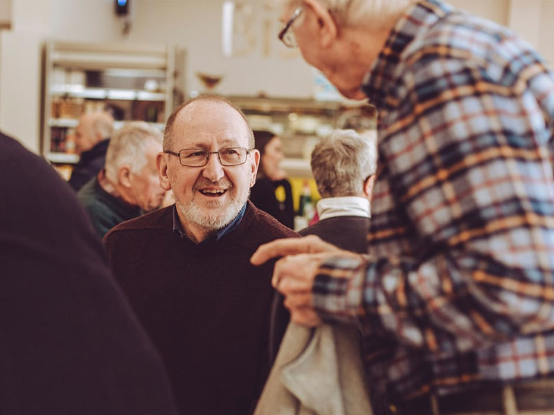 Men chatting in coffee shop